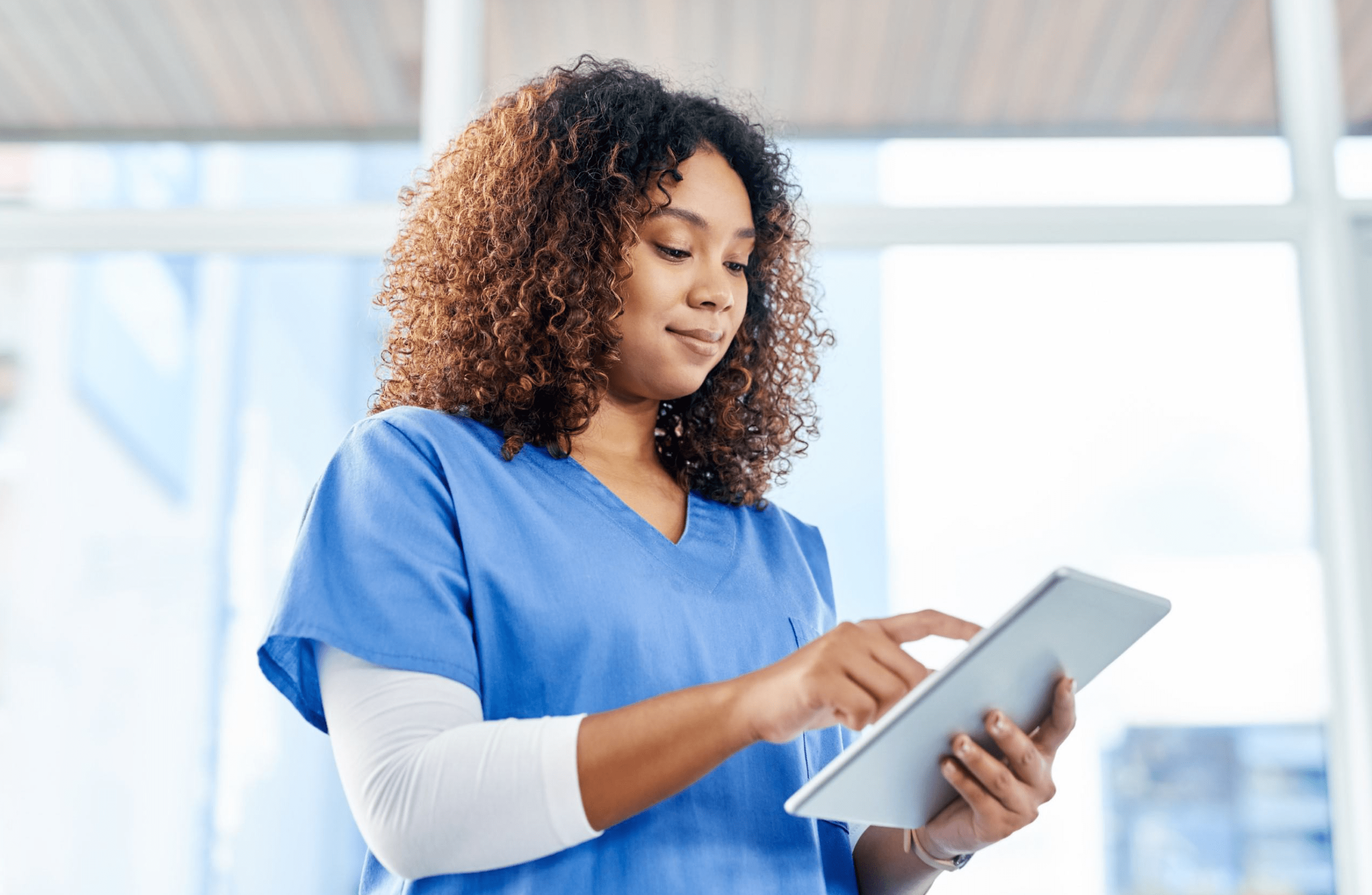 Medspa employee uses medical spa software on her tablet